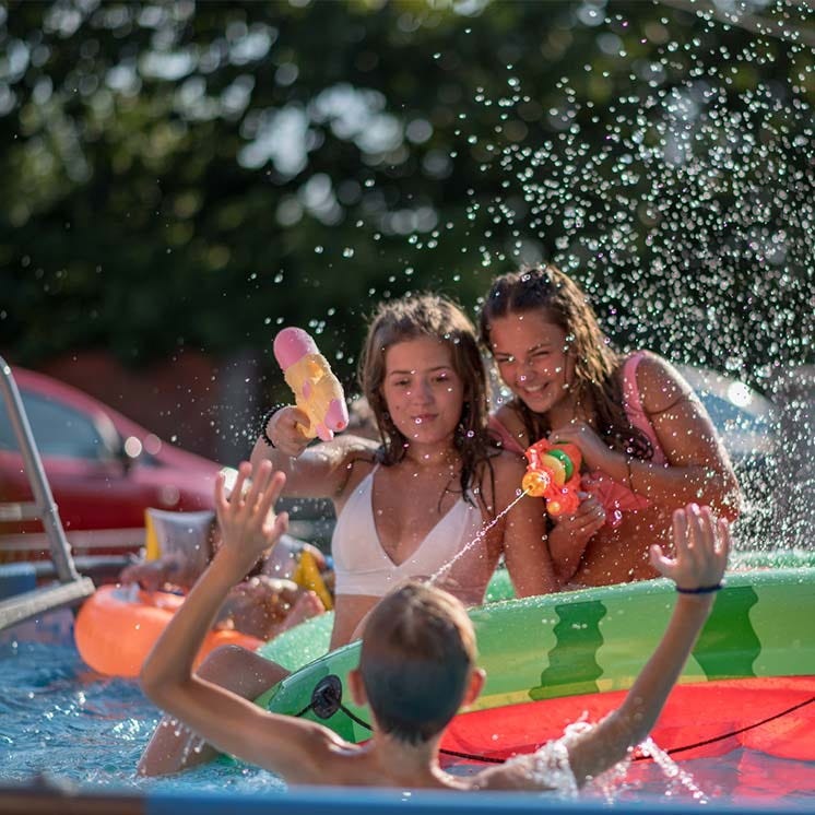 Group of young kids playing in a pool